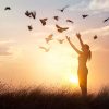 61706692_woman-praying-and-free-bird-enjoying-nature-on-sunset-background-539x363-q40
